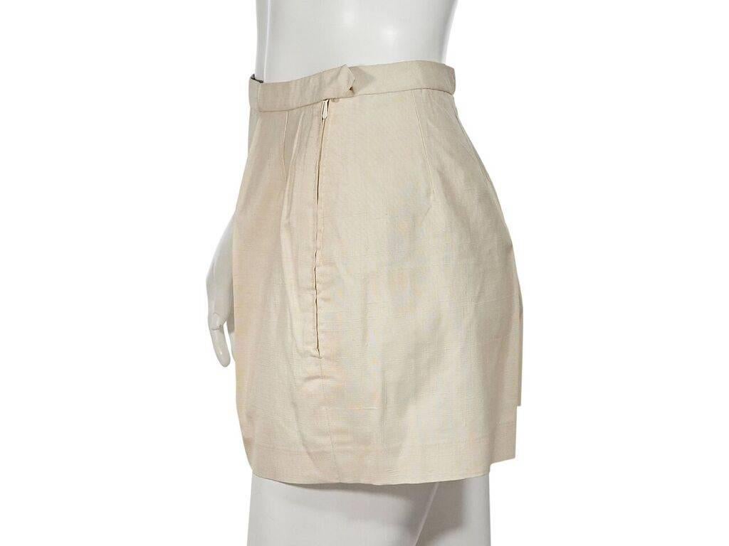 Product details:  Vintage ivory silk shorts by Emilio Pucci.  Banded waist.  Concealed hook and side zip closure.  26