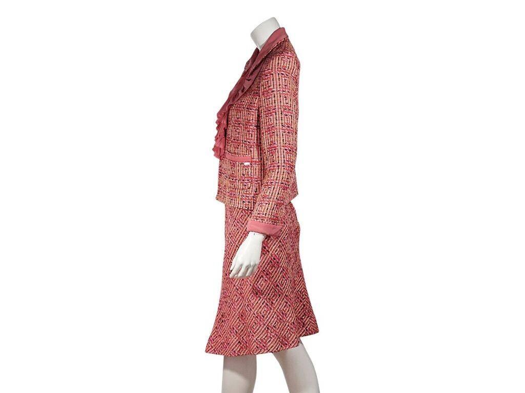 Product details:  Multicolor tweed skirt suit set by Chanel.  Point collar.  Long sleeves.  Concealed hook closure with ruffle trim.  Waist patch pockets.  Matching skirt.  Concealed zip closure.  Jacket:  40