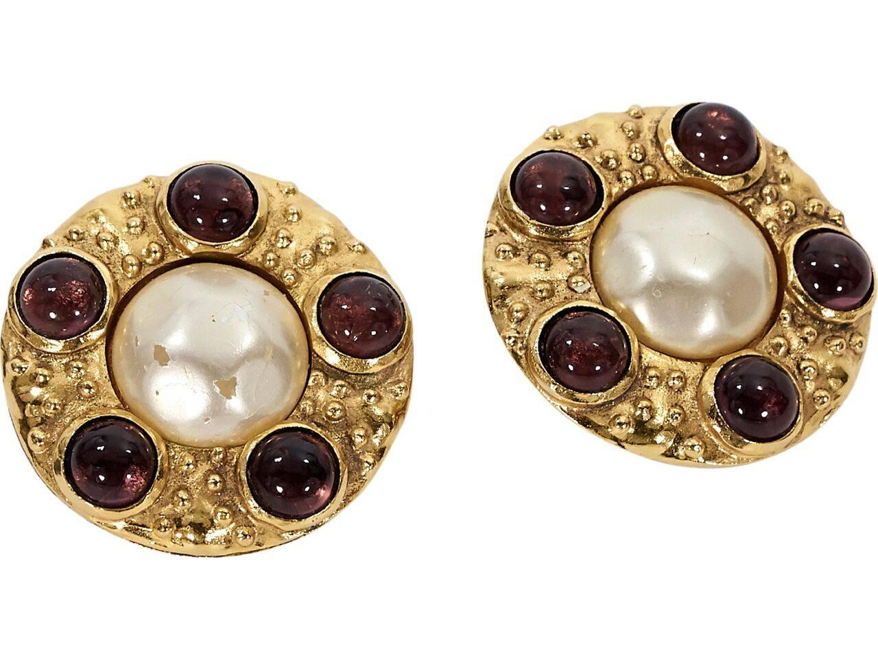 Product details:  Vintage round goldtone earrings by Chanel.  Accented with stones and pearl.  Clip-on backing.  1.5