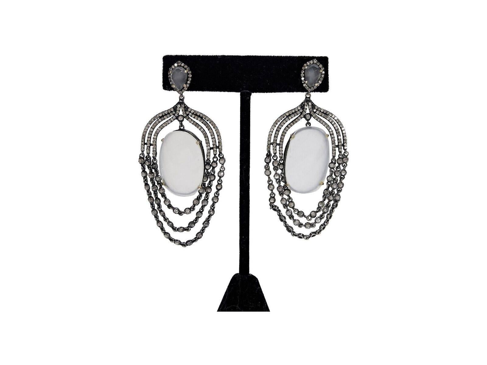Product details:  Gunmetal-tone diamond encrusted chandelier earrings by Jennifer Miller.  Large center stone.  Post closure.  2