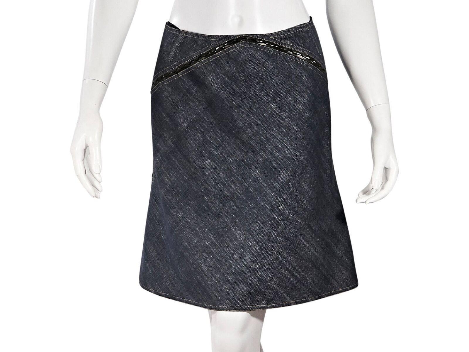 Product details:  Blue denim skirt by Alaia.  Trimmed with leather.  Double exposed back zip closures.  28