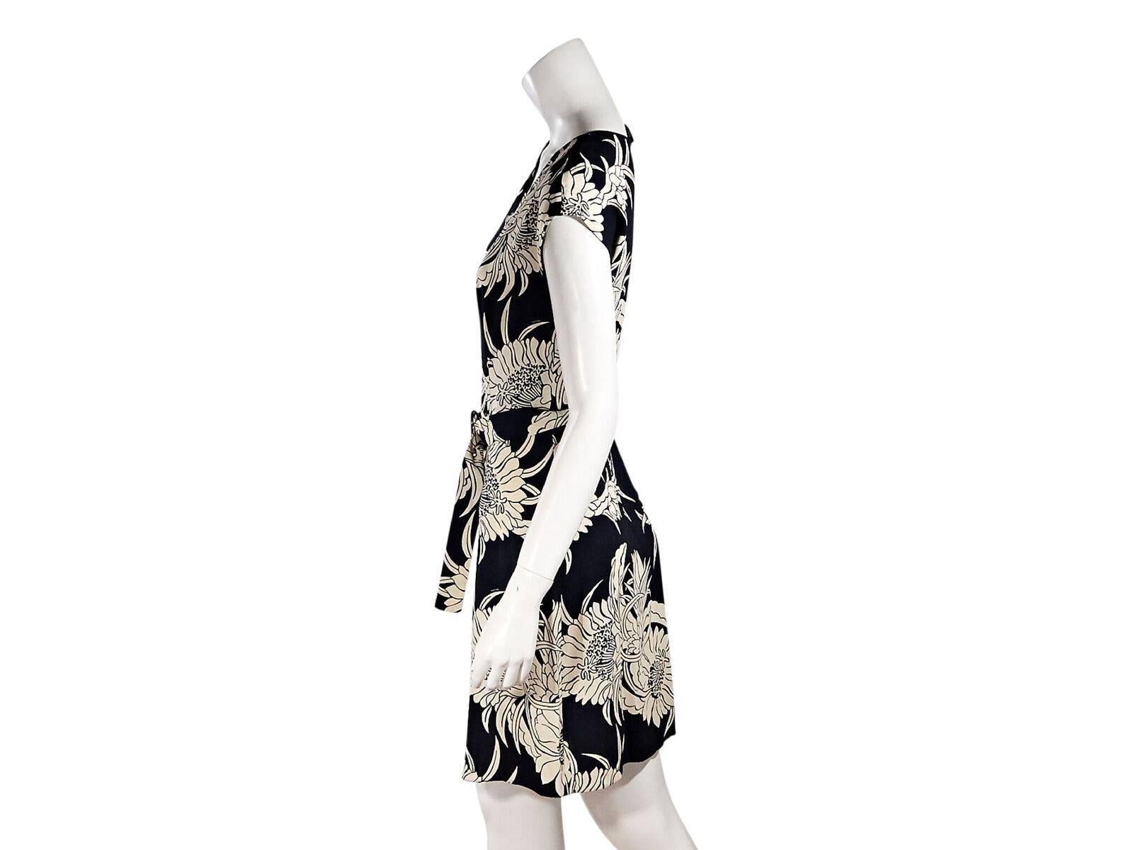 Product details:  Navy blue and white floral-printed jersey dress by Prada.  Deep scoopneck.  Cap sleeves.  Exposed zip-front closure.  Adjustable belted waist.  38