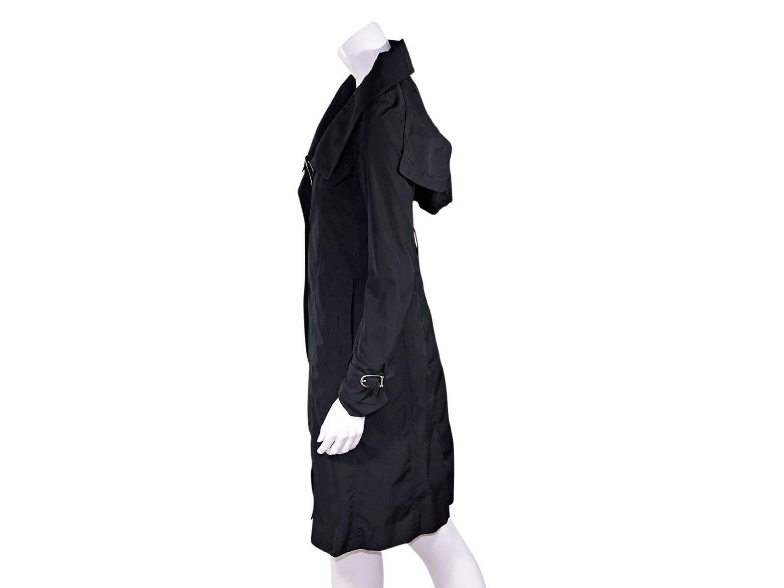 Product details:  Black hooded trench coat by Burberry London.  Spread collar.  Long sleeves.  Adjustable buckle cuff strap.  Concealed snap placket over zip-front closure.  Waist slide pockets.  Back center hem vent.  Label size UK 6.  32