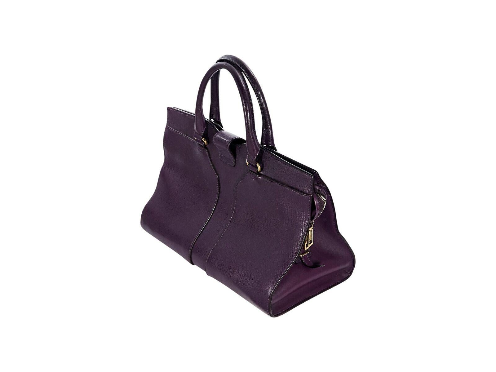 Product details:  Purple Cabas Chyc tote bag by Yves Saint Laurent.  Dual carry handles.  Logo strap over top zip closure.  Lined interior with inner zip and open pockets.  Protective metal feet.  Goldtone hardware.  14