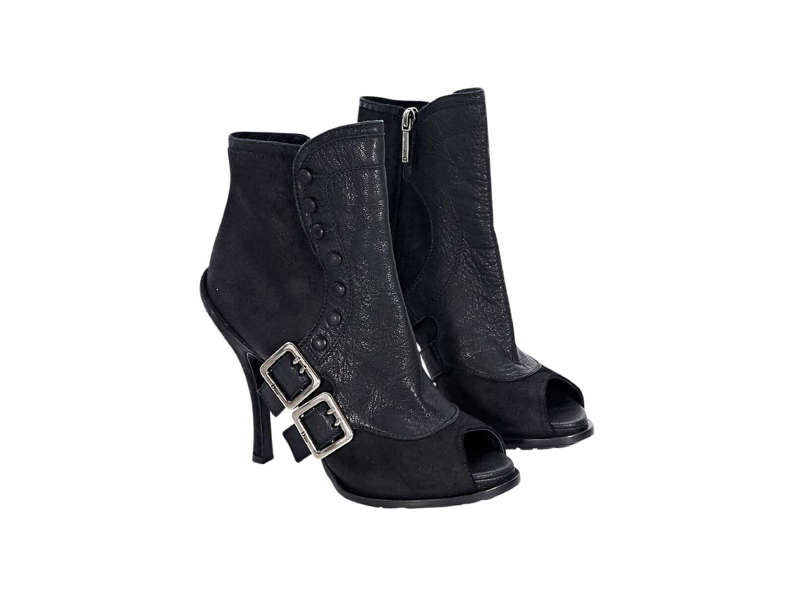 Product details:  Black leather ankle boots by Christian Dior.  Accented with double buckle accents.  Inner zip closure.  Open toe.  Silvertone hardware.  EU size 38.5.  5.5
