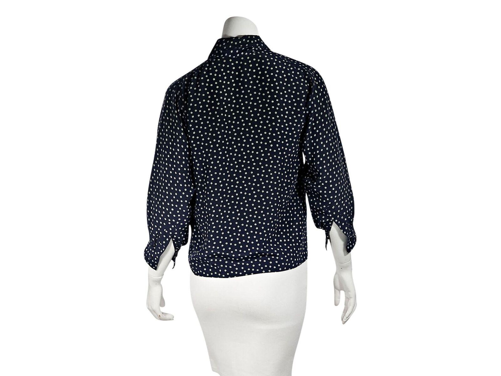 Product details:  Navy blue printed blouse by Yves Saint Laurent.  Spread collar with pussy bow.  Three-quarter length sleeves.  Single button cuffs.  Button-front closure.  38