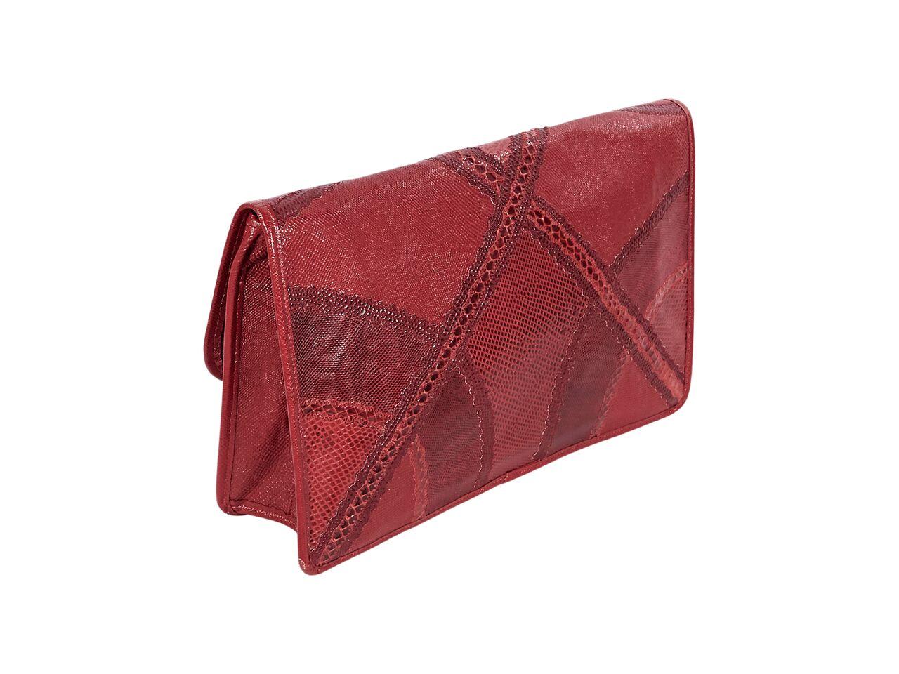 Product details:  Vintage red large exotic skin clutch by Carlos Falchi.  Front flap with concealed magnetic snap closure.  Lined interior with inner slide pocket.  13.25