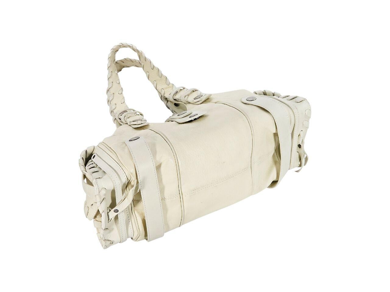 Product details:  White leather shoulder bag by Chloe.  Whipstitched trim.  Dual shoulder straps.  Top strap over zip closure.  Lined interior with inner zip pocket.  Side exterior snap flap pockets.  Silvertone hardware.  15