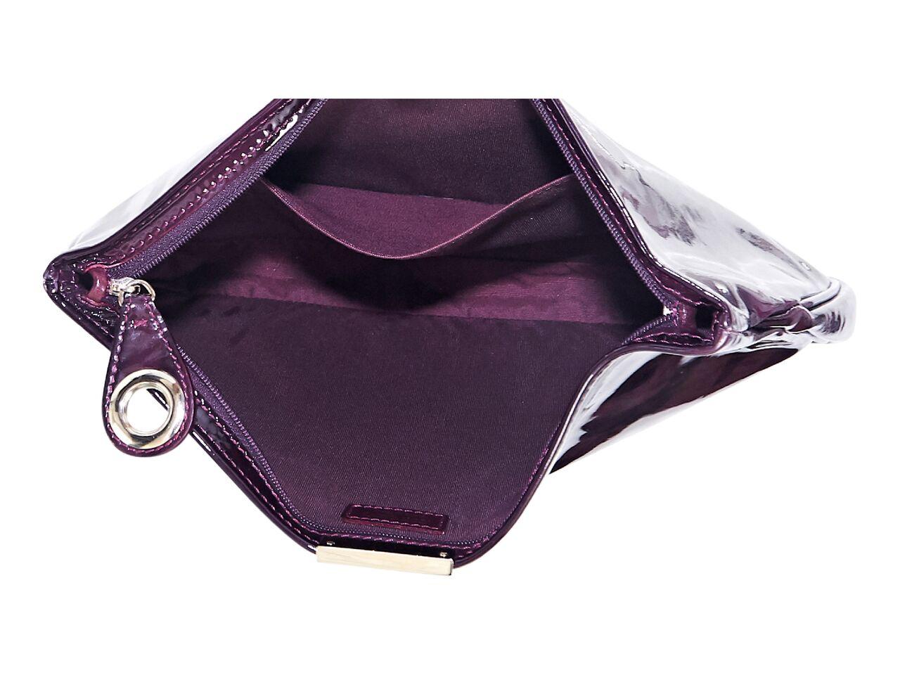 Product details:  Purple and black printed patent leather clutch by Jimmy Choo.  Top zip closure.  Lined interior with inner slide pocket.  Goldtone hardware.  12