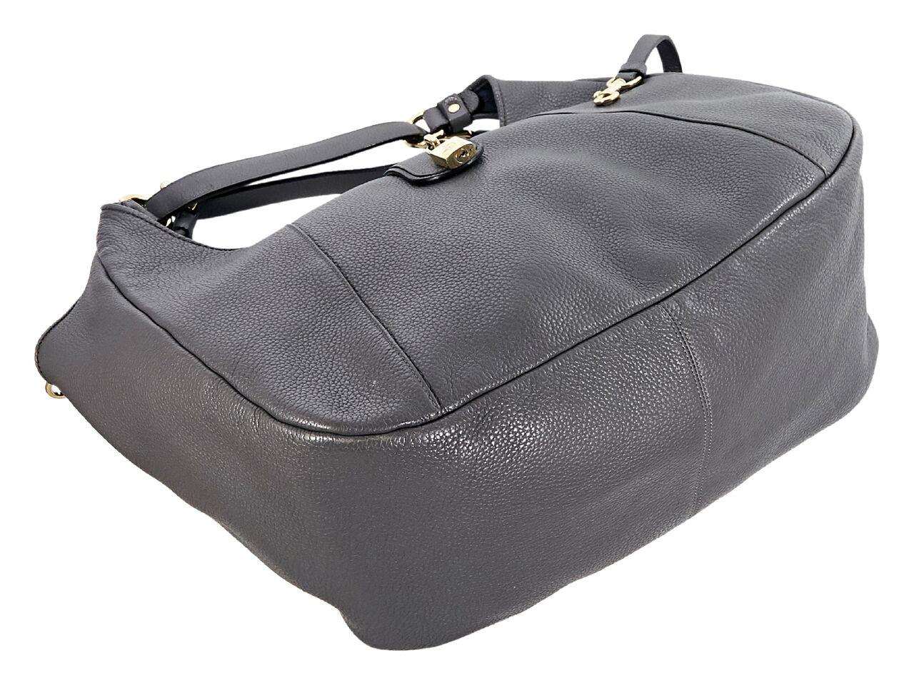 Product details:  Large grey leather hobo bag by Loewe.  Dual shoulder straps.  Top strap with padlock detail.  Lined interior with inner zip and slide pockets and attached key fob.  Goldtone hardware.  Dust bag included.  16.25