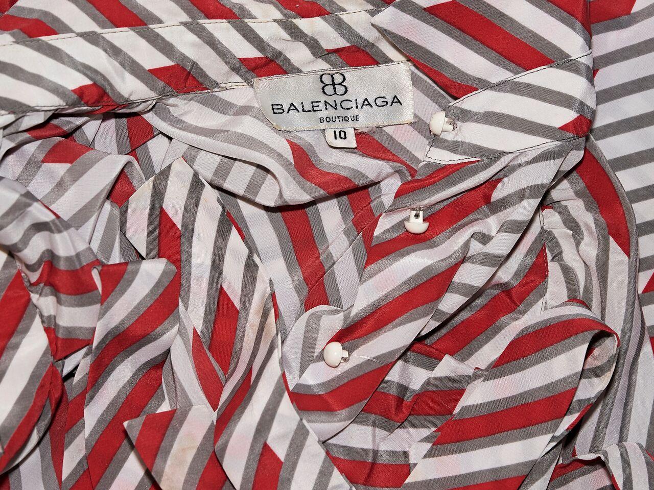 Product details:  Vintage red and white striped blouse by Balenciaga.  Spread collar.  Short sleeves.  Button-front closure.  Matching self-tie belted waist.  34