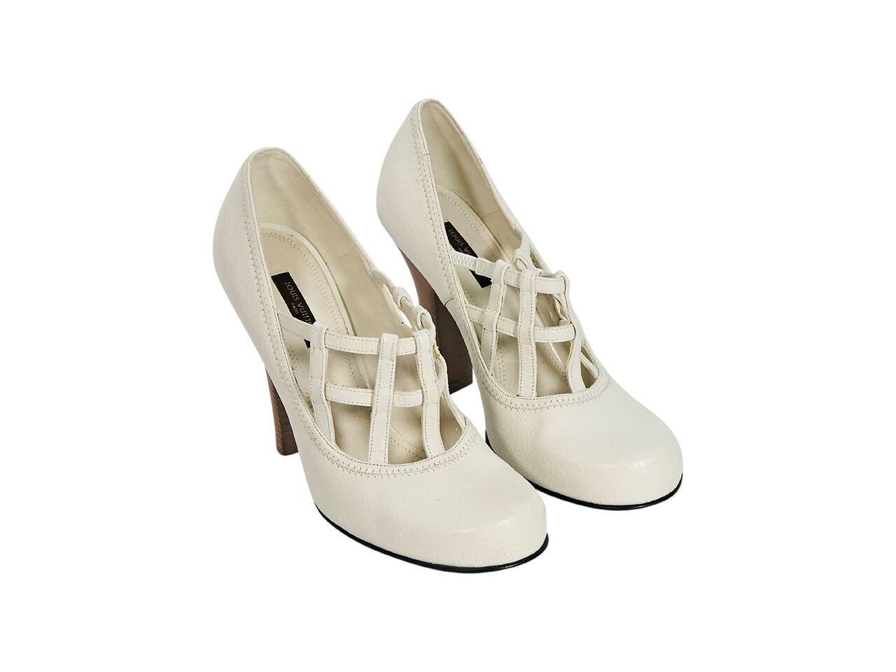 Product details:  White leather pumps by Louis Vuitton.  Stretch inset strappy cage design.  Round toe.  Chunky stacked heel.  4