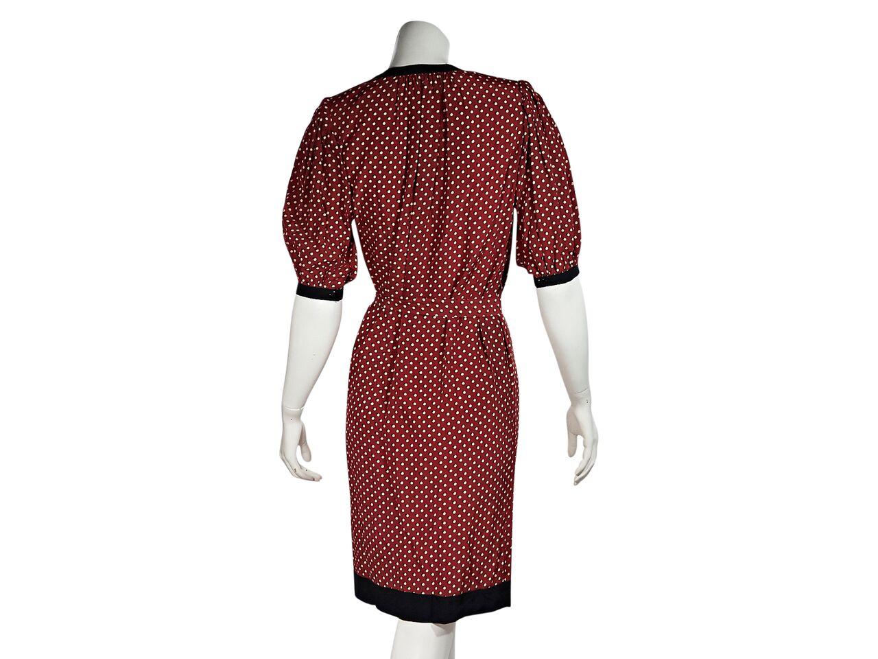 Product details:  Vintage red polka-dot printed tea dress by Emanuel Ungaro.  Circa the 1970s/1980s.  Crewneck.  Elbow-length sleeves.  Quarter button-front placket.  Self-tie belted waist.  43