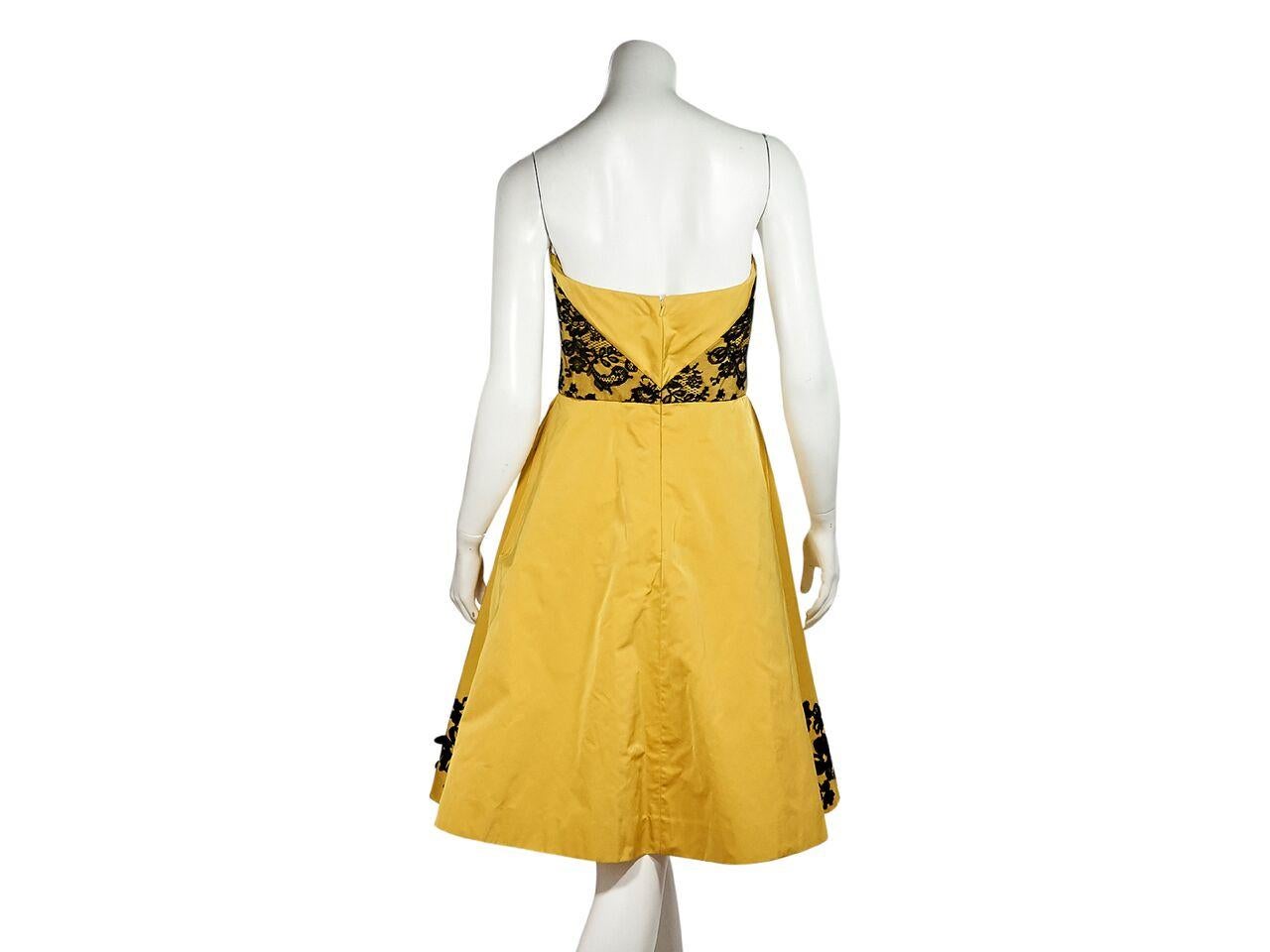 Product details:  Yellow strapless cocktail dress by Oscar de la Renta.  From the 2016 Resort collection.  Accented with black beaded lace.  Sweetheart neckline.  Inset boning for support.  Concealed back zip closure.  31