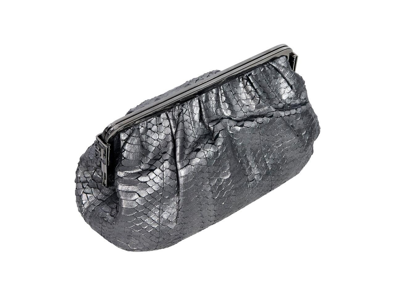 Product details:  Metallic silver snakeskin clutch by Judith Leiber.  Side clasp closures.  Lined interior with inner slide pocket.  Original tags included.  9