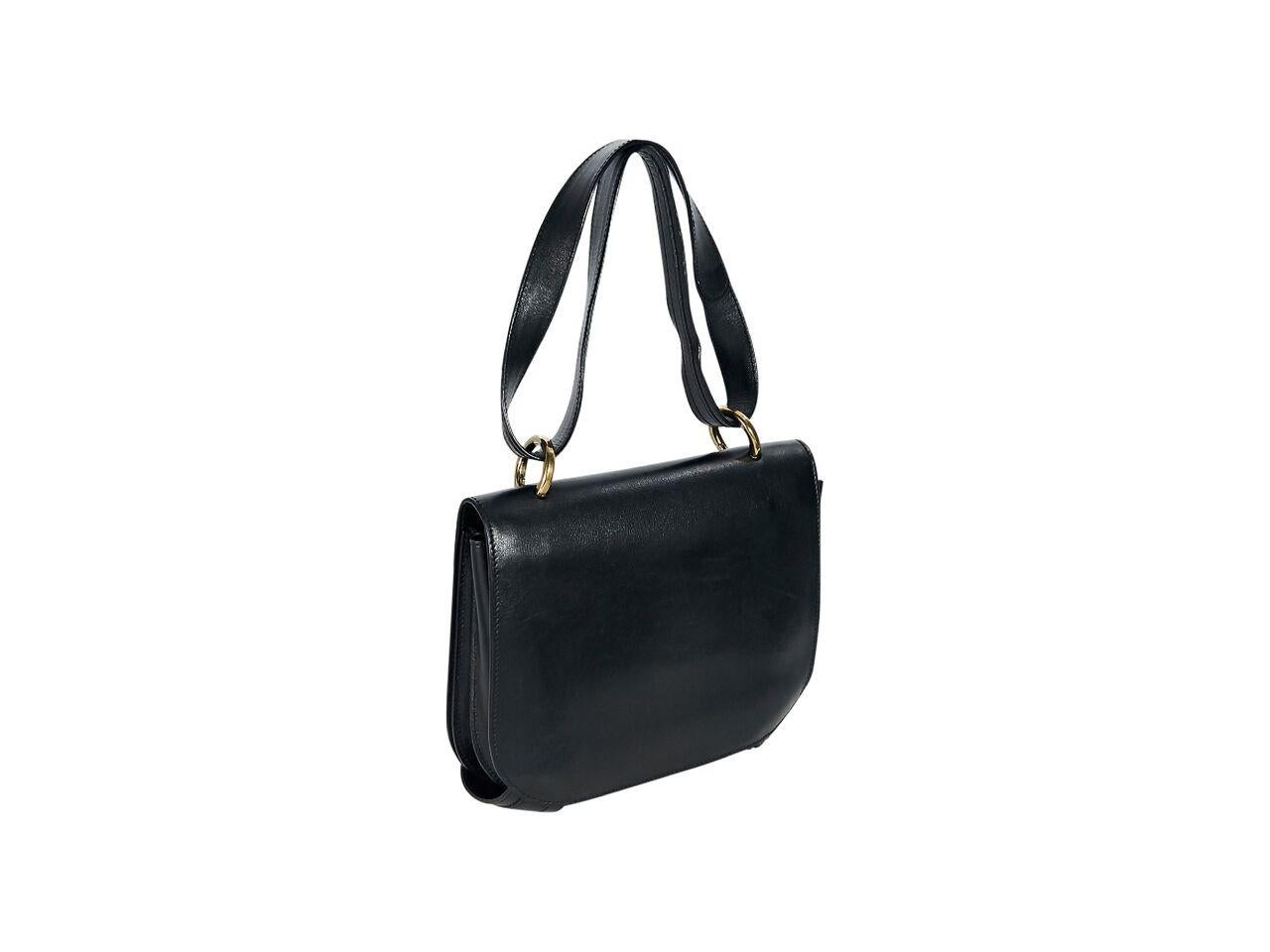 Product details:  Black leather shoulder bag by Salvatore Ferragamo.  Shoulder strap.  Front flap with double strap closure.  Leather lined interior with inner zip and slide pockets.  Goldtone hardware.  9