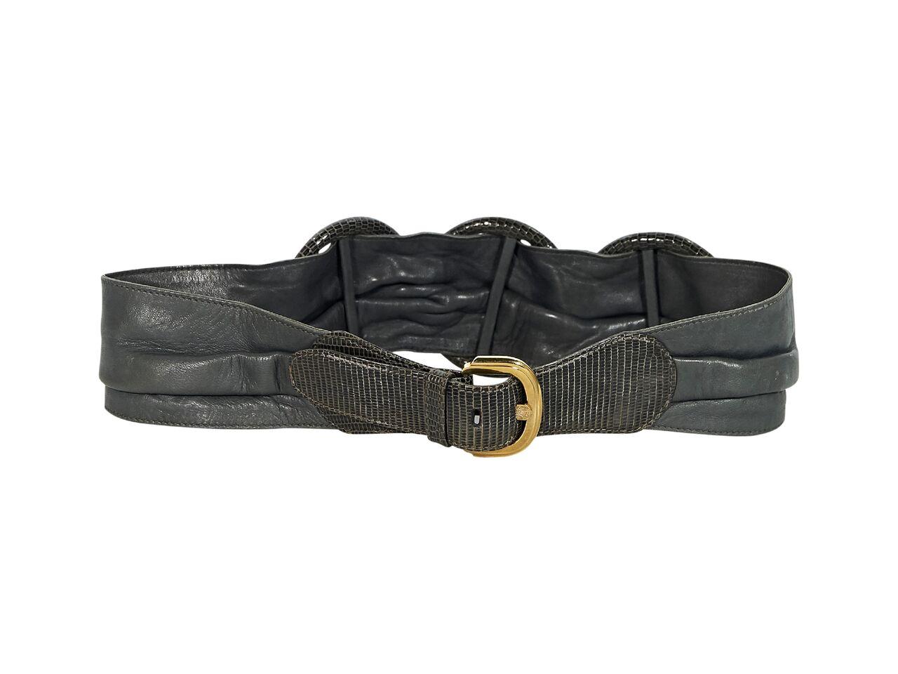 Product details:  Vintage grey leather belt by Gucci.  Accented with snakeskin circular details.  Adjustable buckle closure.  Goldtone hardware.  31.5