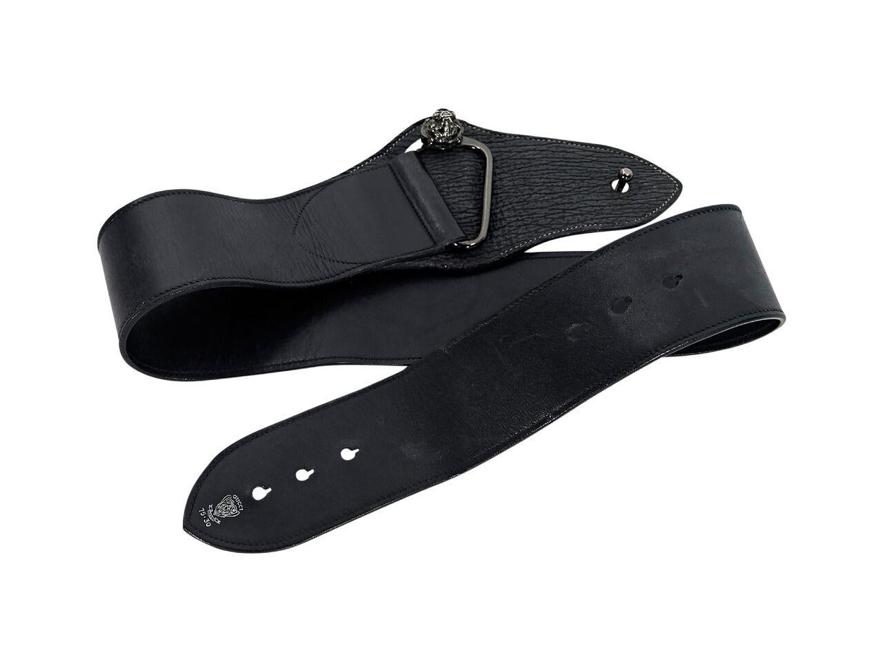 Product details:  Black leather wide belt by Gucci.  Adjustable pin closure.  Gunmetal-tone hardware.  39