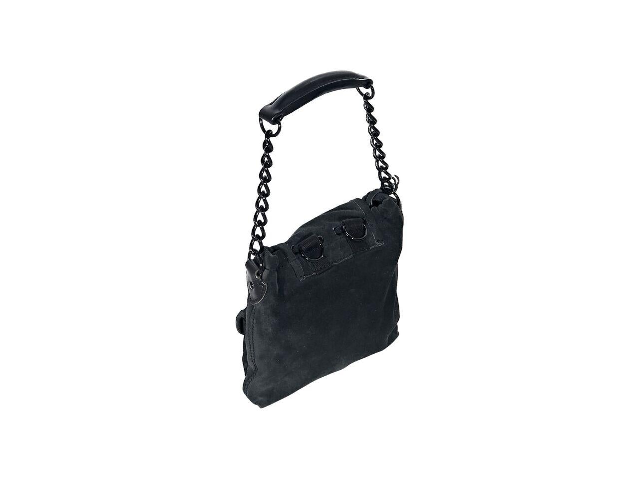 Product details:  Black suede mini sac shoulder bag by Balenciaga.  Single chain carry handle.  Detachable mirror.  Drawstring closure under front flap.  Lined interior with inner zip pocket.  Dual front exterior flap pockets.  Black hardware.  7