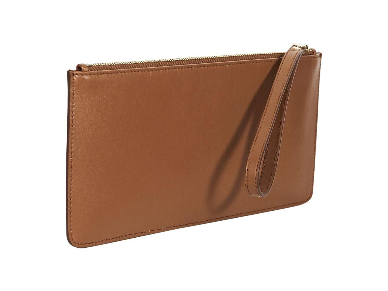 Product details:  Brown leather wristlet pouch by Salvatore Ferragamo.  Wristlet strap.  Top zip closure.  Lined interior.  Perforated logo design at front.  9.5