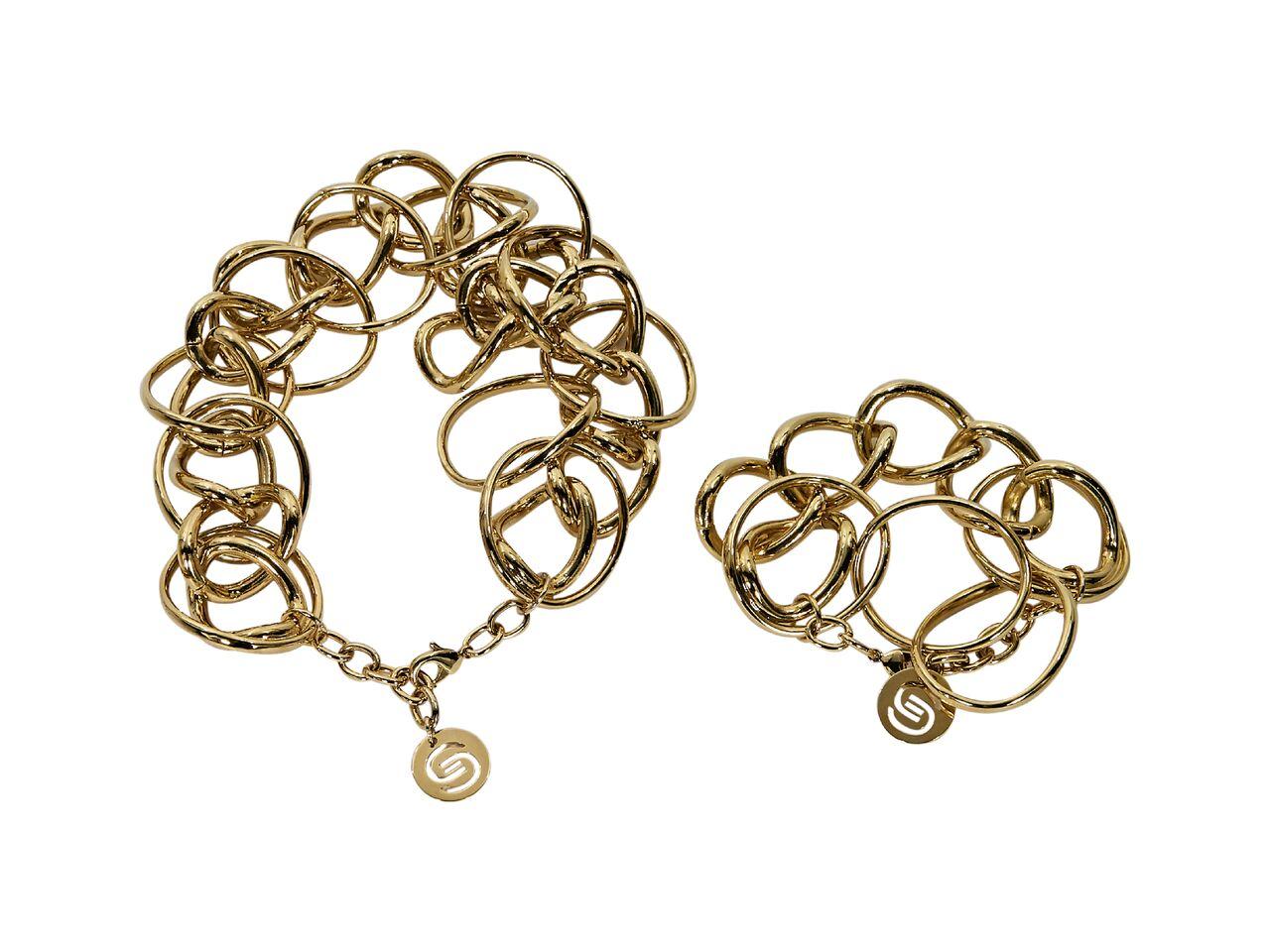 Product details:  Matching goldtone necklace and bracelet set by Elie Saab.  Adjustable lobster clasp closures.  Goldtone hardware.  Dust bag included.  Necklace: 14