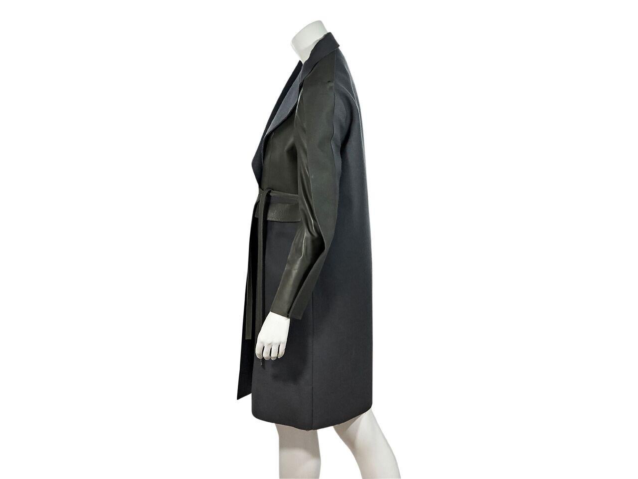 Product details:  Army green leather and grey wool-blend trench coat by Balenciaga.  Notched lapel.  Long sleeves.  Self-tie waist closure. Label size FR36.
Condition: Pre-owned. Very good. 
Est. Retail $ 5,450.00