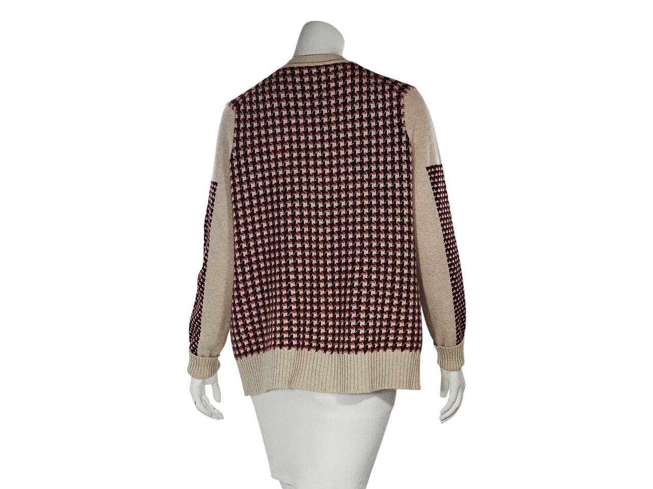 Product details:  Multicolor houndstooth cashmere cardigan by Chanel.  Deep v-neck.  Long sleeves.  Button-front closure.  Button waist pockets.  Ribbed cuffs and hem.  44