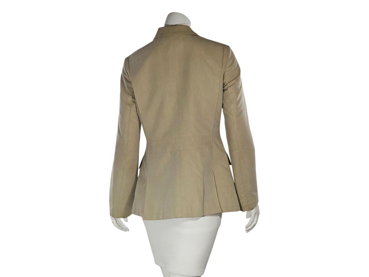 Product details:  Beige cotton-blend jacket by Loro Piana.  Notched lapel.  Long sleeves.  Button-front placket over zip closure.  Chest besom pocket.  Waist flap pockets.  Back double hem vents.  36