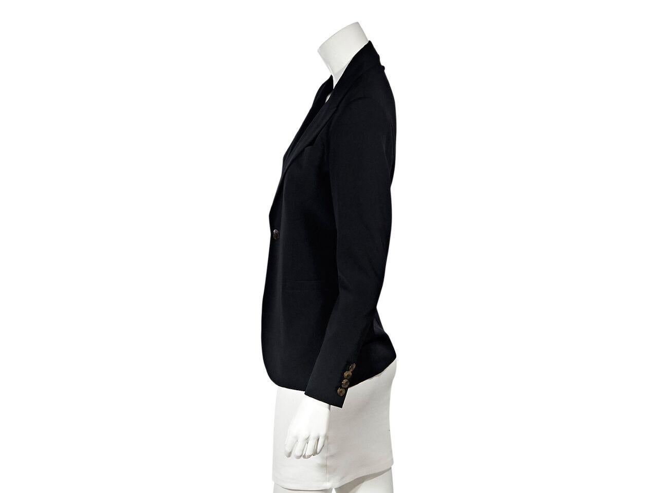 Product details:  Vintage black virgin wool blazer by Jean Paul Gaultier Femme.  Circa the 1990s.  Peak lapel.  Long sleeves.  Four-button detail at cuffs.  Chest and waist besom pockets.  34