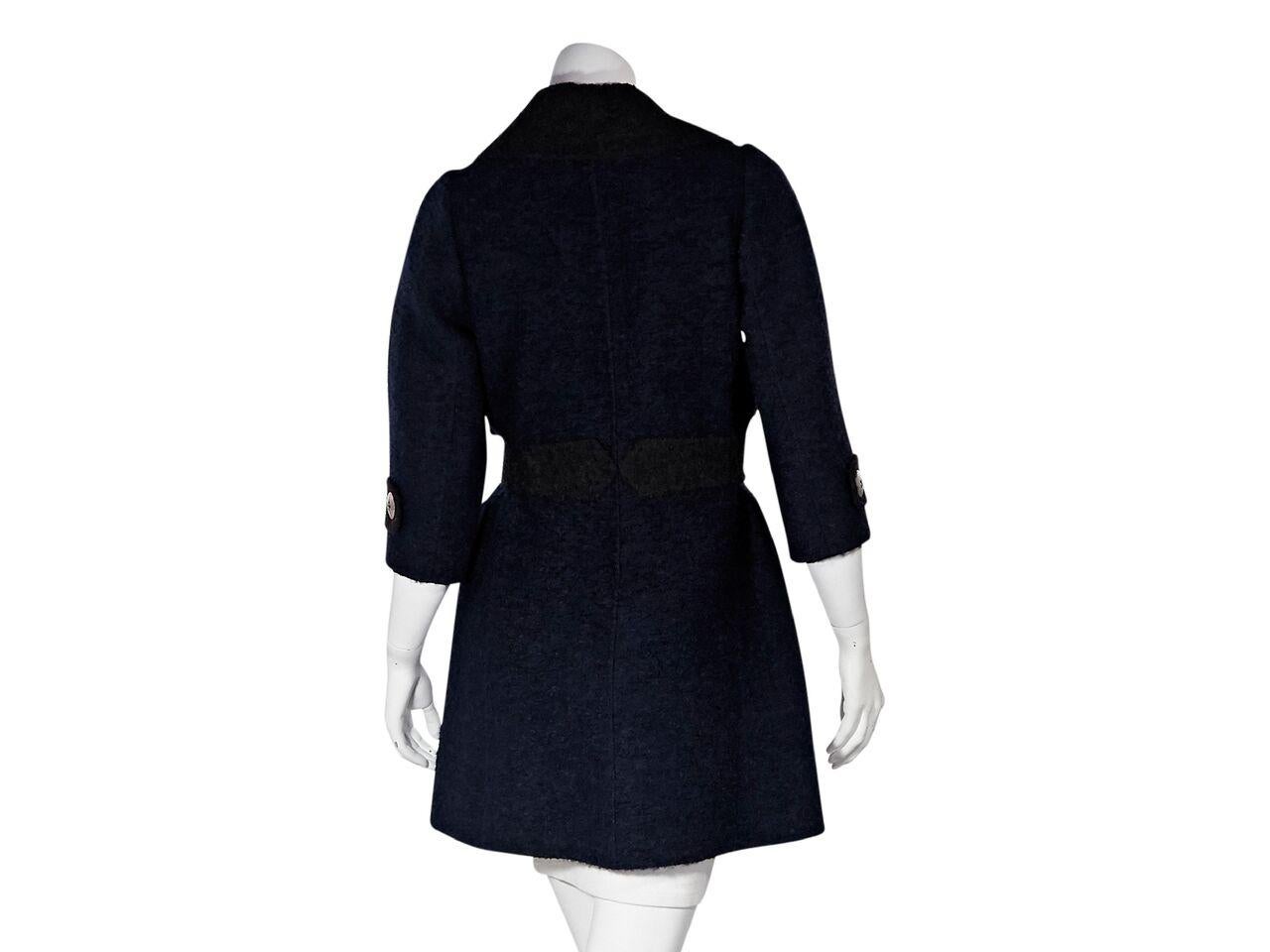 Product details:  Navy blue and dark brown wool-blend coat by Marc Jacobs.  Notched lapel.  Elbow-length sleeves.  Button-front closure.  Self-tie belted waist.  Button flap front pockets.  Silvertone hardware.  35