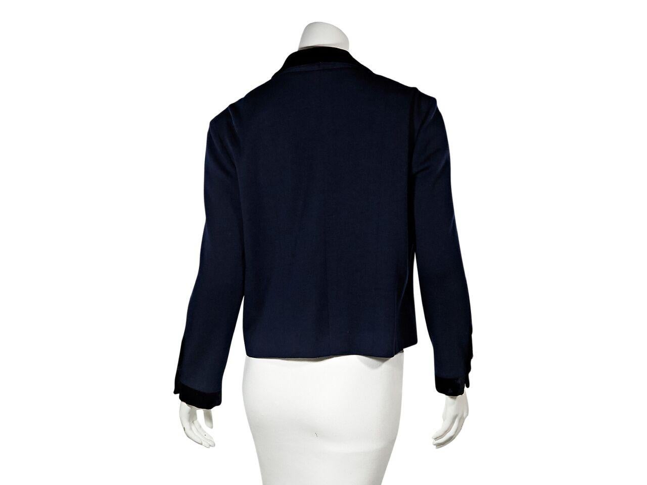 Product details:  Vintage navy blue and black jacket by Chanel.  Trimmed with velvet.  Notched lapel.  Long sleeves.  Button-front closure.  Button front pockets.  Goldtone hardware.  Bust 40