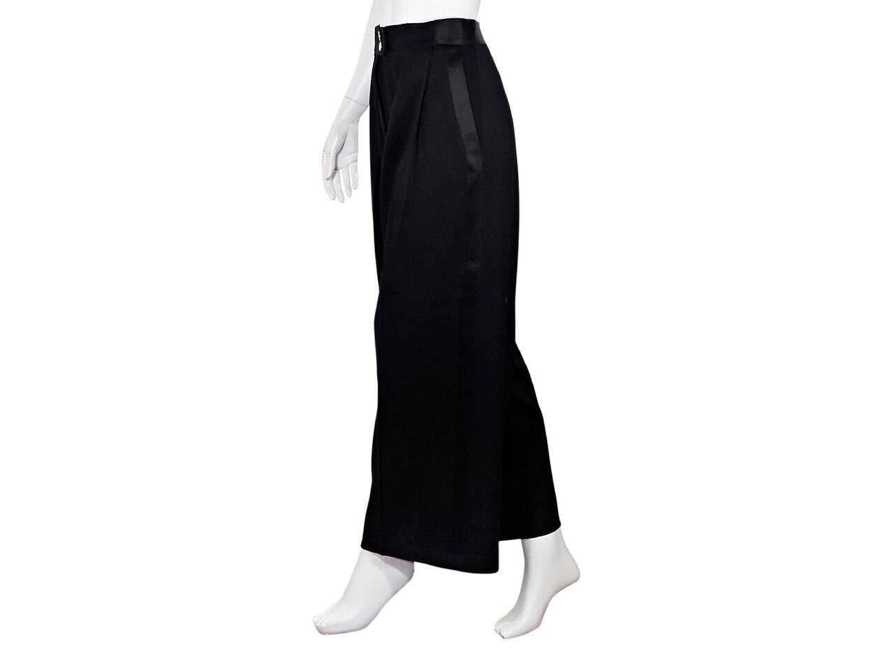 Product details:  Vintage black wool tuxedo palazzo pants by Chanel.  Banded waist.  Button and zip fly closure.  Pleated front.  Waist slide pockets.  28.5