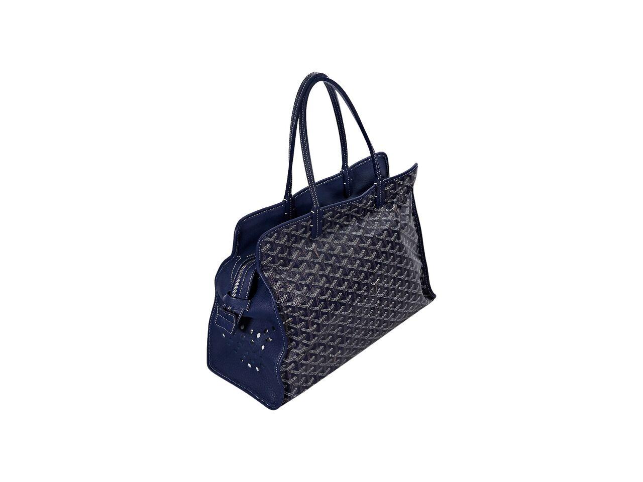 Product details:  Blue Sac Hardy pet carrier PM bag by Goyard.  Trimmed with leather.  Dual shoulder straps.  Top zip closure.  Inner attached snap pouch.  Perforated side panels.  Silvertone hardware.  15.25