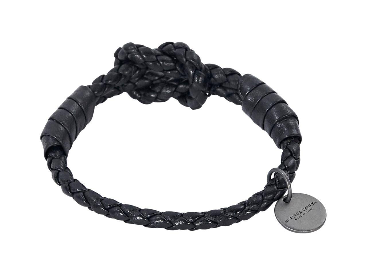 Product details:  Black braided leather bracelet by Bottega Veneta.  Knotted accent.  Gunmetal-tone hardware.  Comes with box.
Condition: Pre-owned. Very good.
Est. Retail $ 270.00