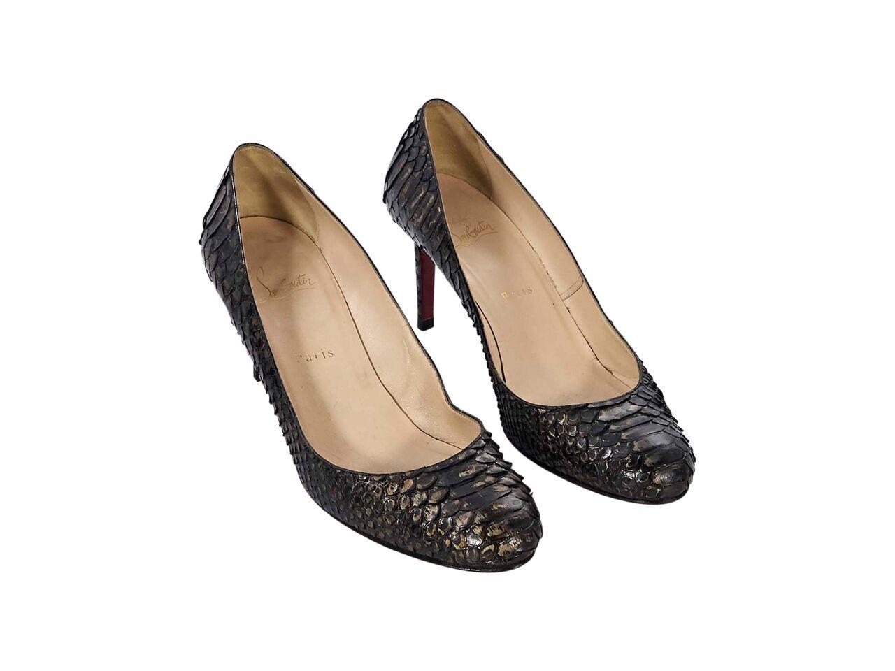 Product details:  Dark brown snakeskin pumps by Christian Louboutin.  Round toe.  Iconic red sole.  Slip-on style.  3