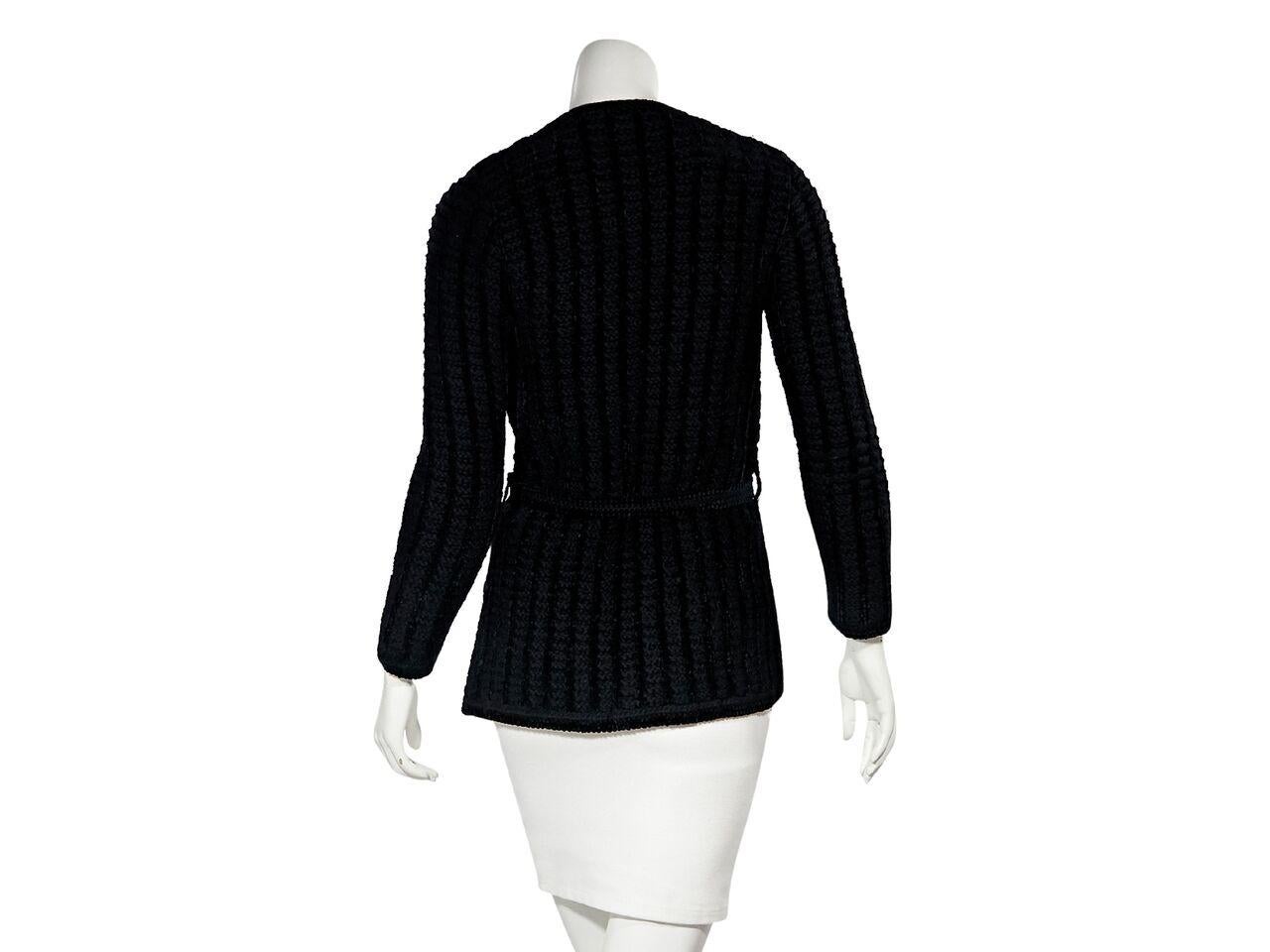 Product details:  Vintage black wool-blend knit cardigan by Yves Saint Laurent Rive Gauche.  Long sleeves.  Self-tie belt.  Waist patch pockets.  32