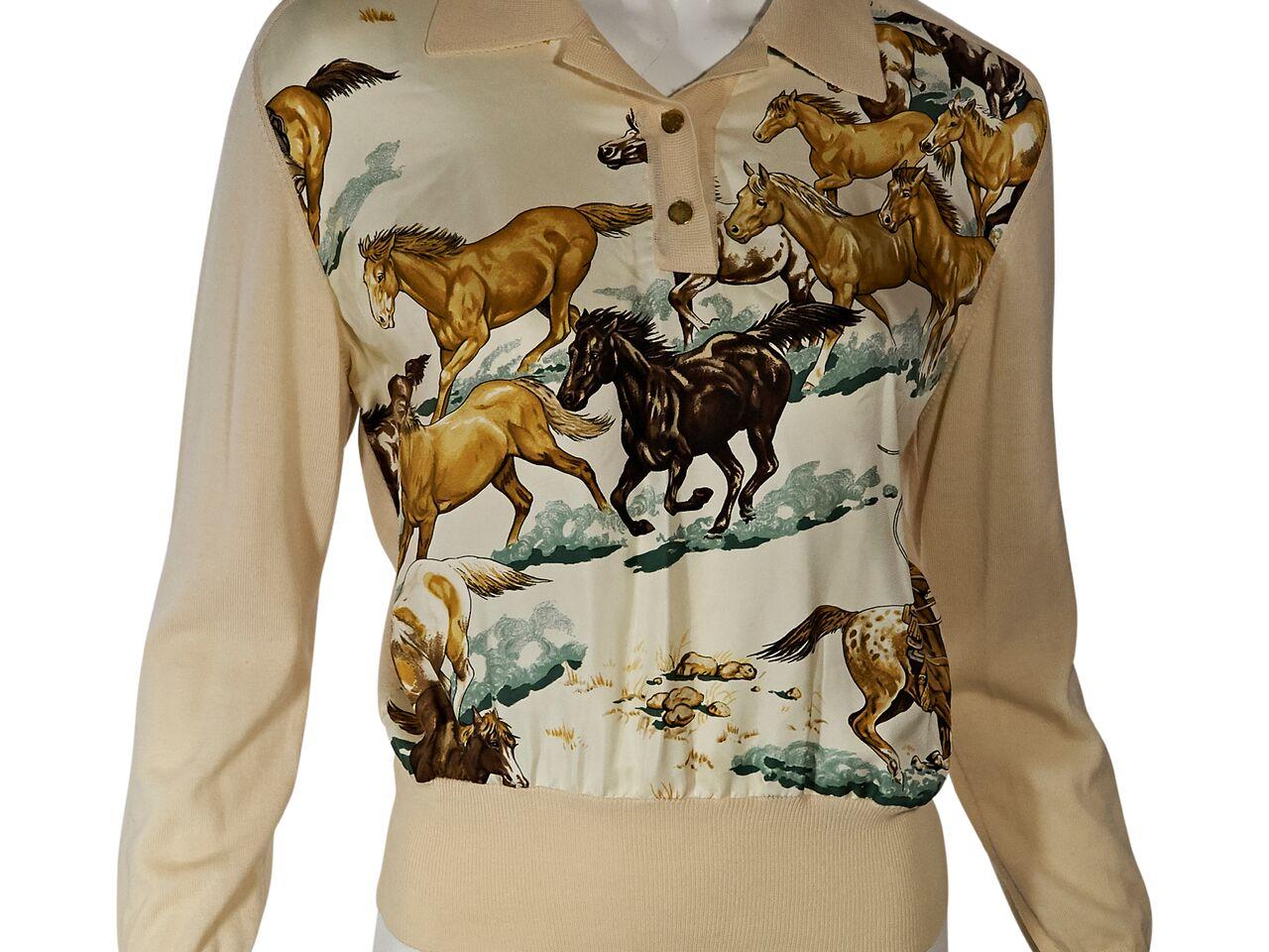 Product details:  Cream wool sweater by Hermes.  Horse-printed silk front.  Spread collar.  Long sleeves.  Ribbed cuffs and hem.  Pullover style.  37.5