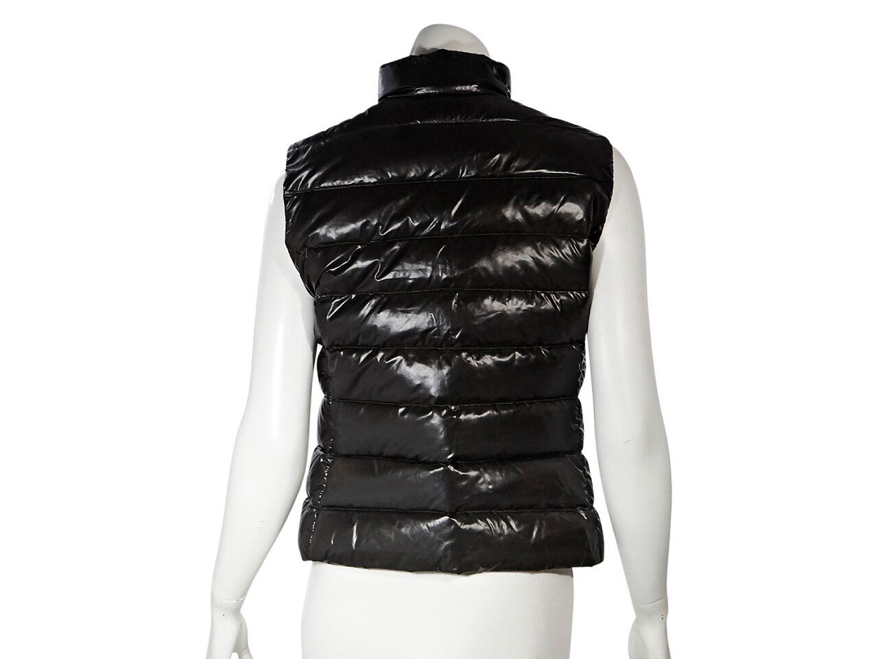 Product details:  Dark brown down filled vest by Moncler.  Stand collar.  Zip-front closure.  Concealed on-seam zip pockets.  40