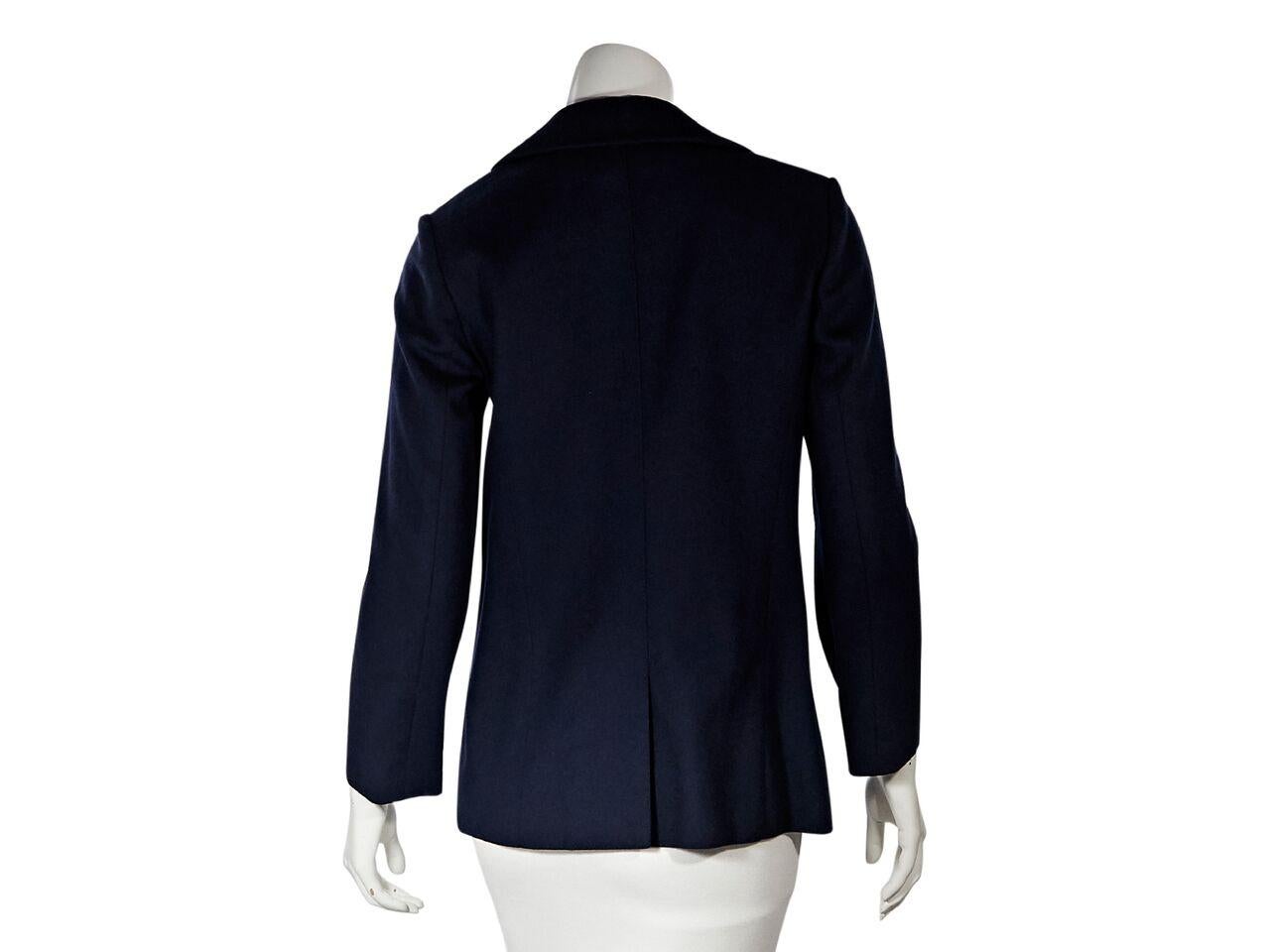 Product details:  Navy blue wool jacket by Hermes.  Spread collar.  Long sleeves.  Button-front closure.  Waist patch pocket.  Center back hem.  Goldtone hardware.  35