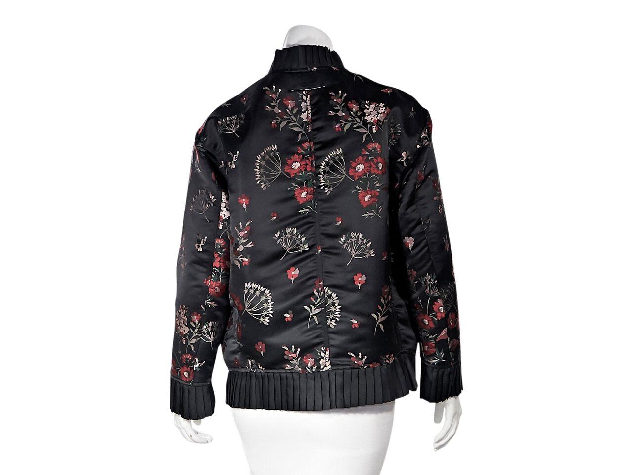 Product details:  Black and red floral bomber jacket by MM6 Maison Margiela.  Stand ruffle collar.  Long sleeves.  Ruffled cuffs.  Zip-front closure.  Waist snap flap pockets.  Ruffled hem.  28