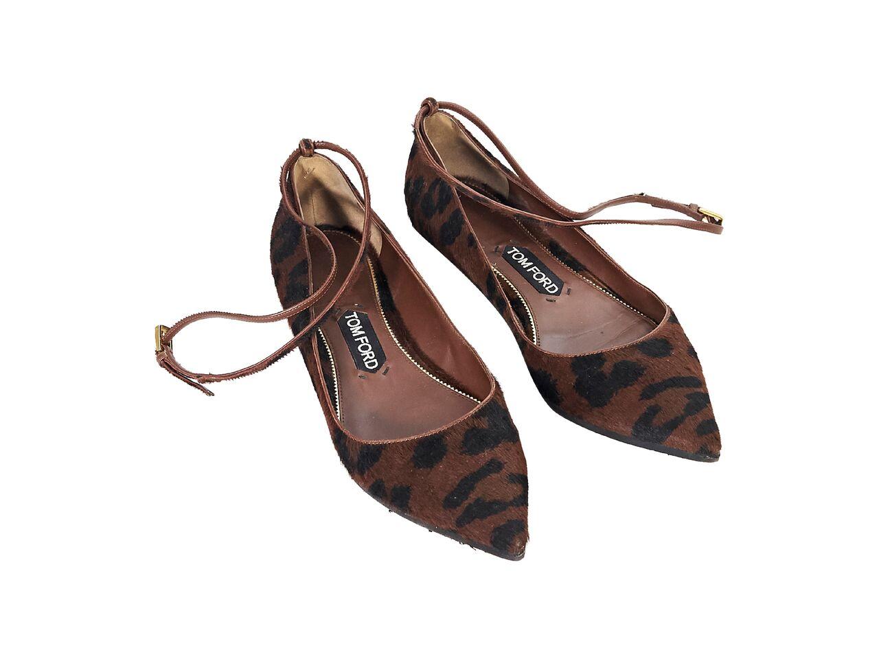 Product details:  Brown and black animal-printed pony hair ballet flats by Tom Ford.  Adjustable ankle strap.  Point toe.  
Condition: Pre-owned. Very good. 
Est. Retail $ 1,195.00