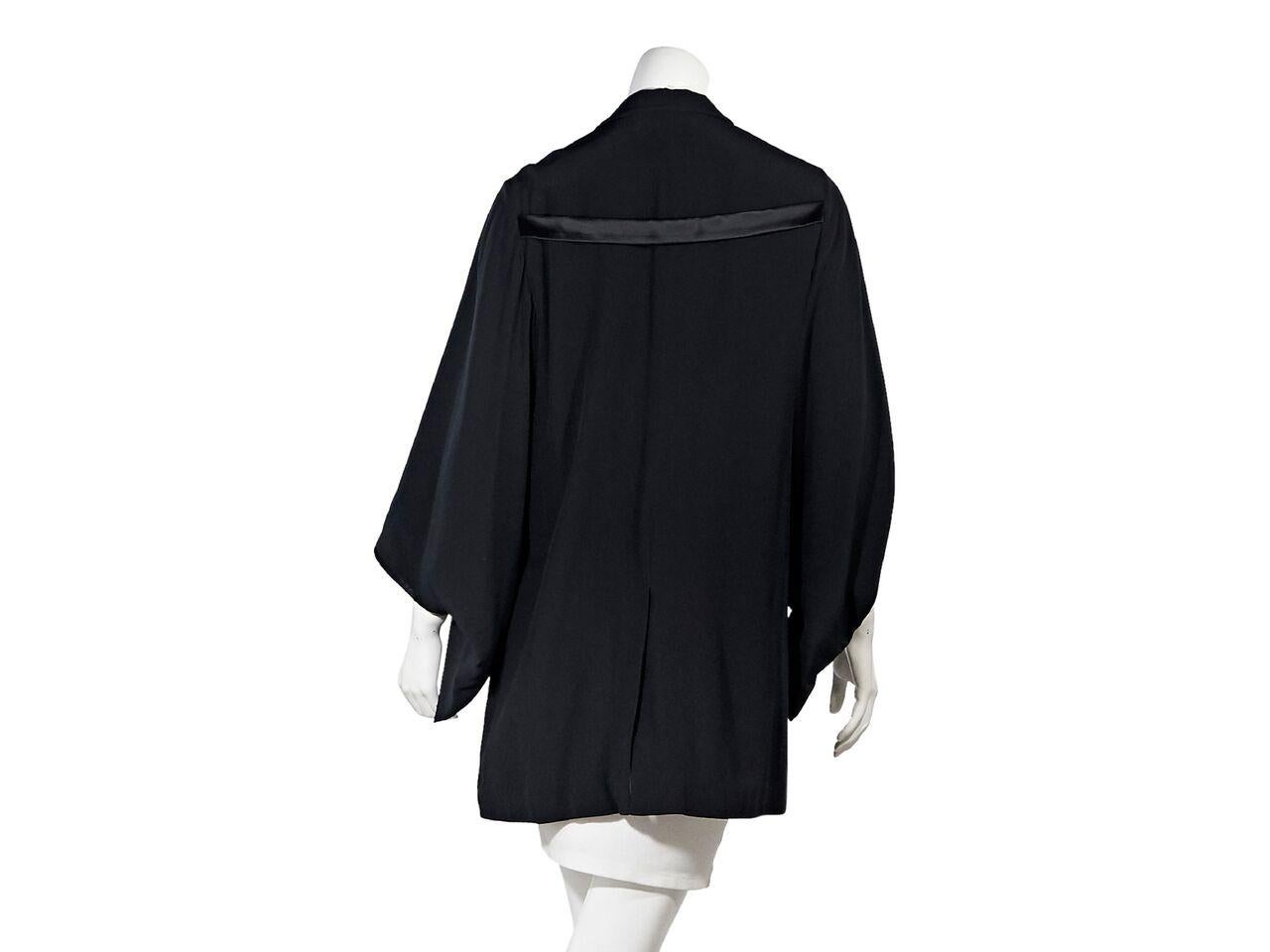 Product details:  Black silk kimono blazer by Givenchy.  Notched lapel.  Long kimono sleeves.  Single button closure.  Waist flap pockets.  Back center hem vent.  Label size FR 42.  38