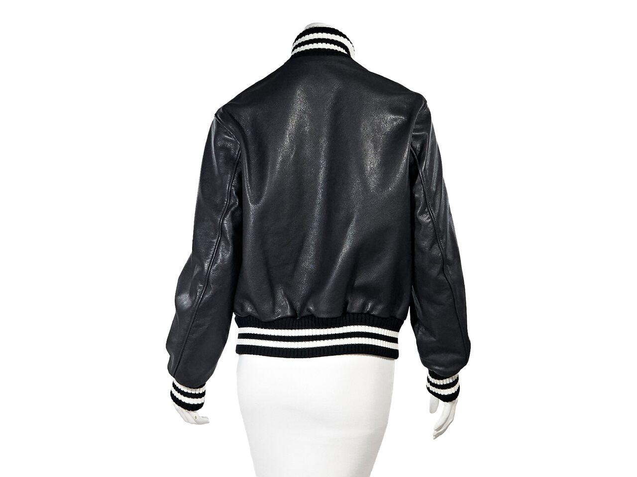 Product details:  Black leather varsity bomber jacket by R13.  Accented with stripes.  Stand collar.  Long sleeves.  Snap-front closure.  Slide waist pockets.  37