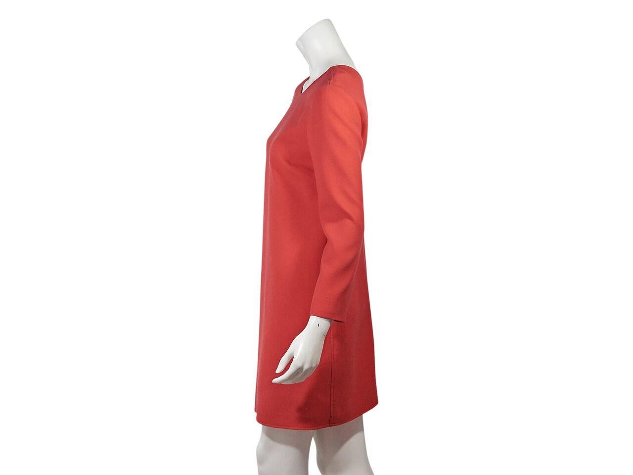 Product details:  Orange shift dress by Victoria Victoria Beckham.  Roundneck.  Long sleeves.  V-back.  Concealed back zip closure.  35