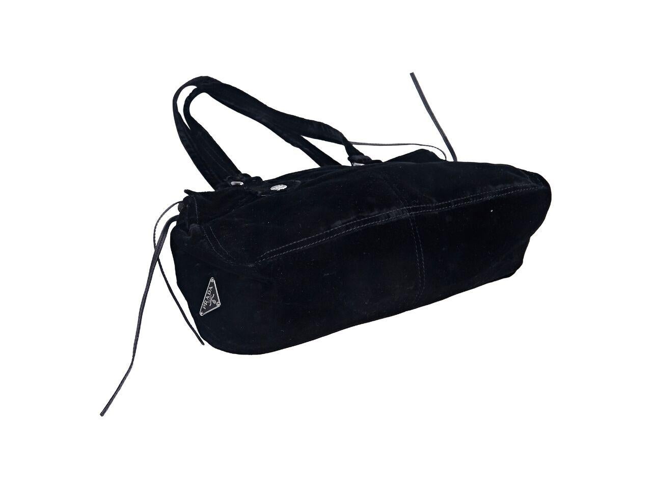 Product details:  Black velvet suede shoulder bag by Prada.  Dual shoulder straps.  Open top.  Lined interior with inner zip pocket.  Cinched sides.  Silvertone hardware.  16