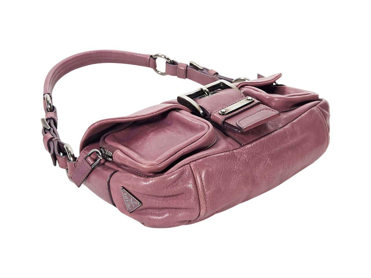 Product details:  Purple leather shoulder bag by Prada.  Single shoulder strap.  Front flap with buckle closure.  Exterior zip pockets under front flap.  Gunmetal-tone hardware.  10