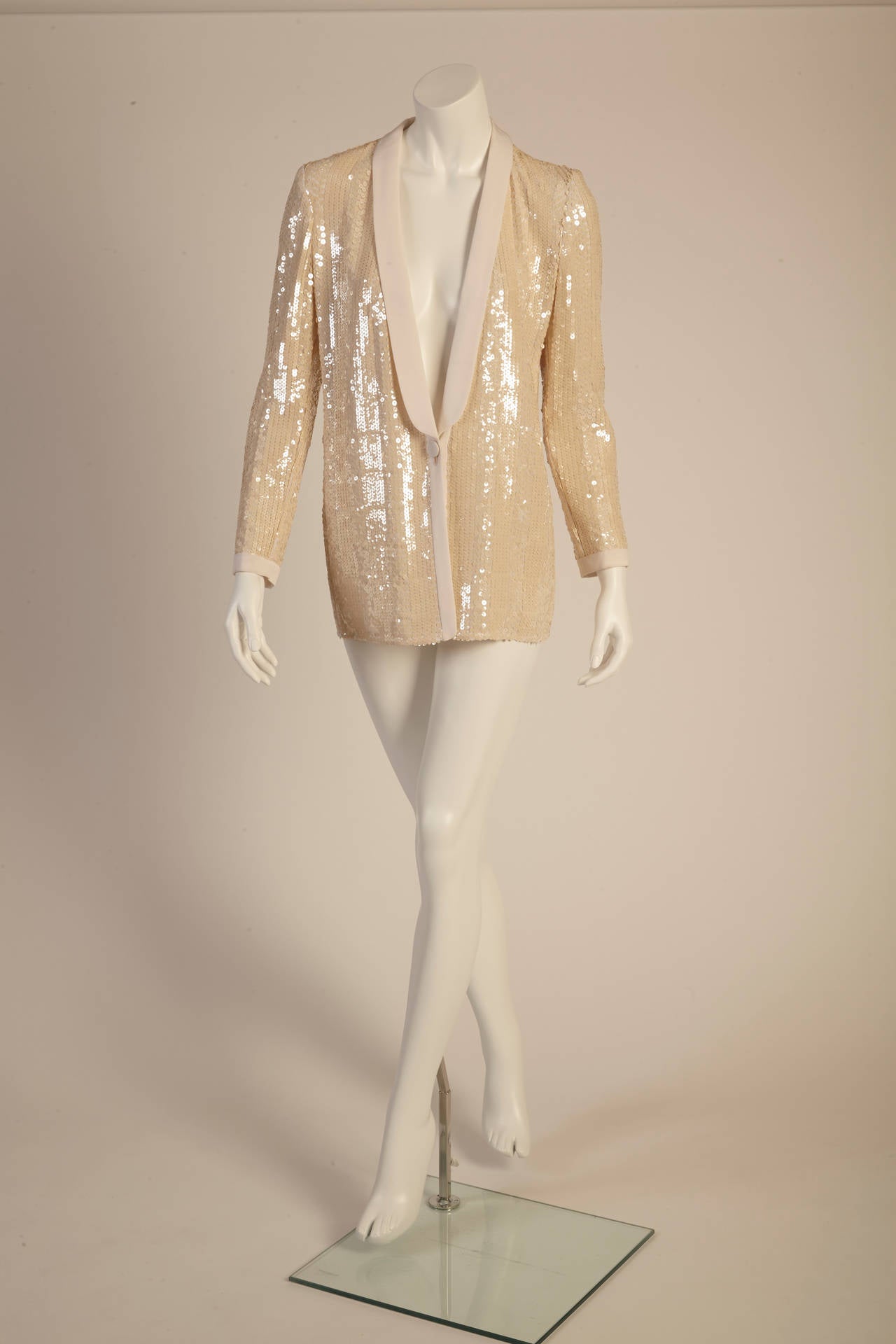Both refined and glamorous, this dazzling Giorgio Armani Iridescent pearl sequin jacket is perfect for your next big event. Silk trim on the collar and sleeves and closes with a single button.  In excellent, barely worn condition.