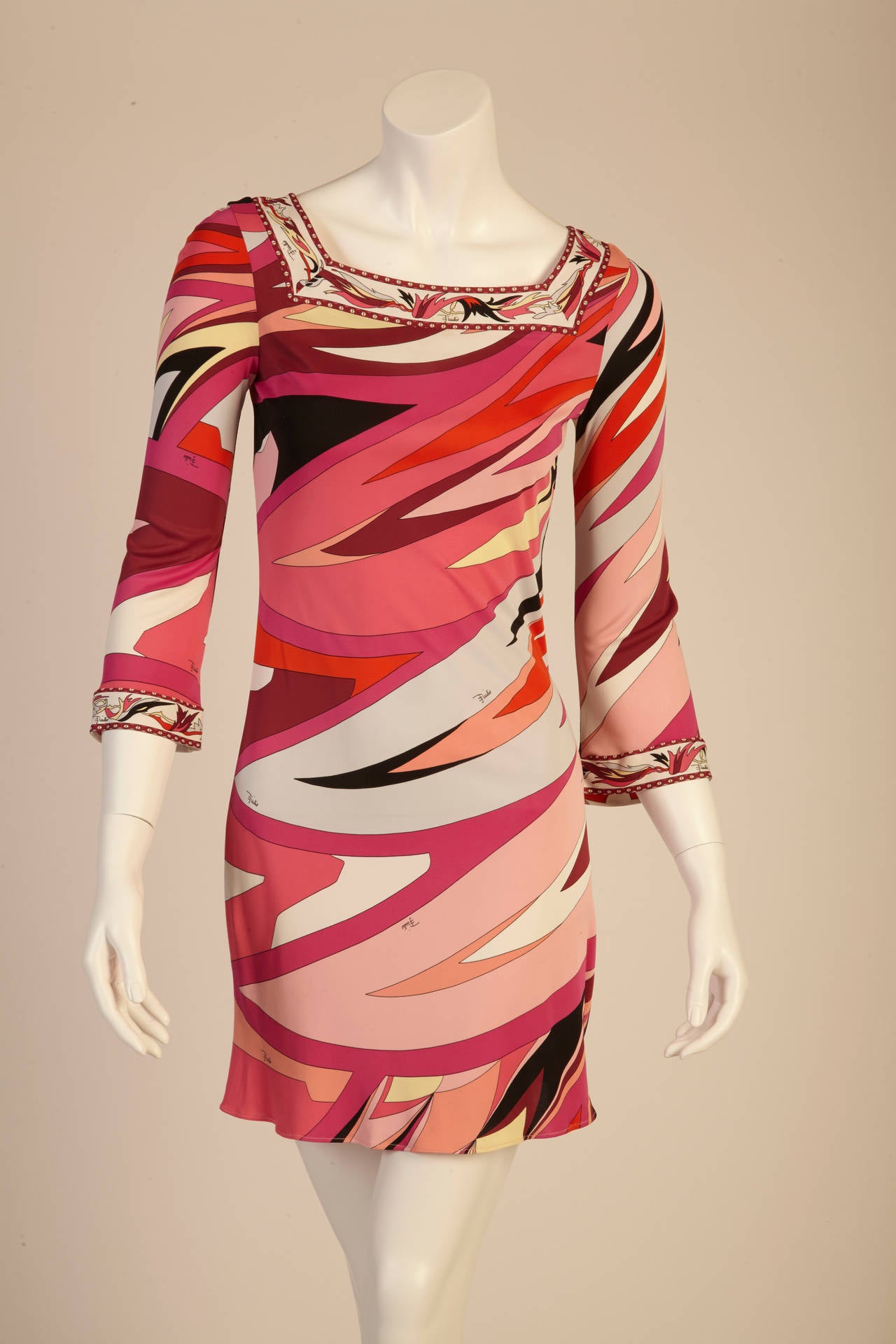 This exquisite dress in its printed silk blend is an Emilio Pucci classic. Contains a stunning square neckline and ¾ sleeves. A decorative, printed border trims the square neckline and cuffs. Adds a wonderful splash of coral colors to any casual or