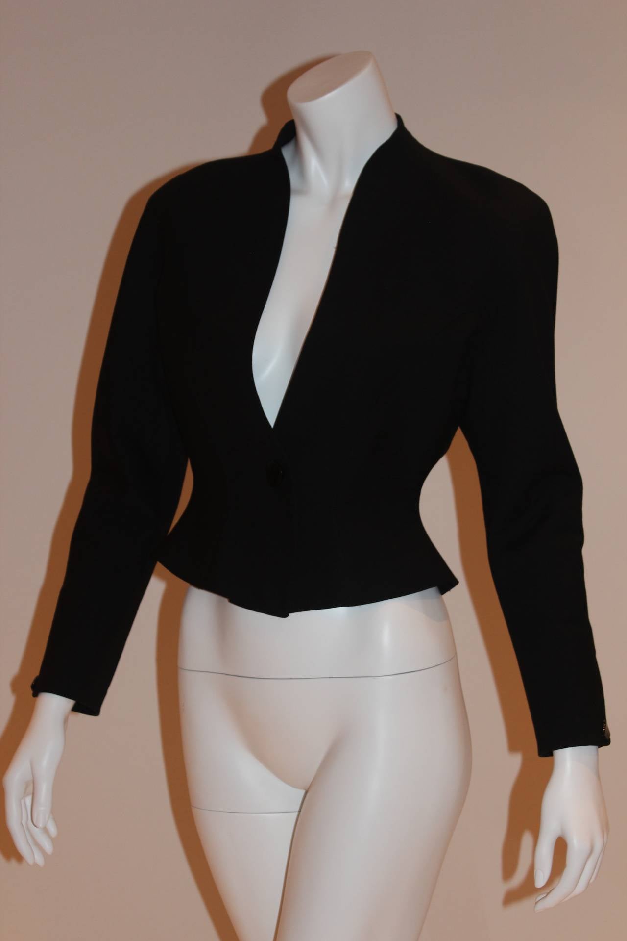 With its complimentary, plunging V-neckline and front button closure, this exceptional Thierry Mugler design is absolutely stunning. Jacket is well structured, flattering, and in excellent, barely worn condition.