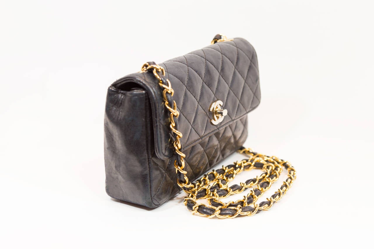 This beloved Chanel cross-body bag is hands-free and crafted to perfection. Contains two-laced chain link shoulder straps, gold-tone hardware, quilted lines and a single flap, CC logo closure. This purse is the ultimate day-to-night bag, and is